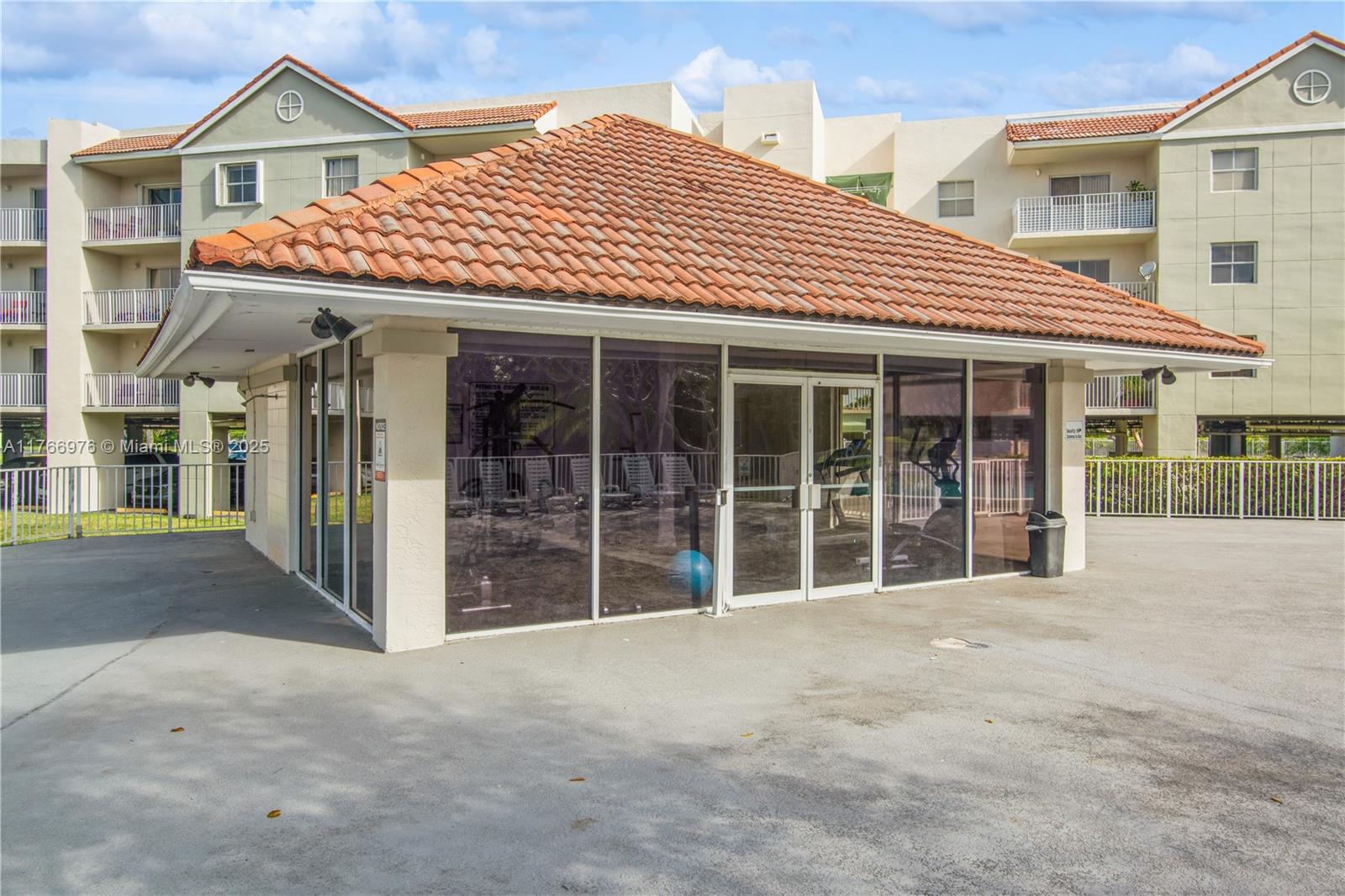 8200 Southwest 210th Street, Unit 111 Cutler Bay, FL 33189 - Photo 23 of 23 a view of a white house with large windows