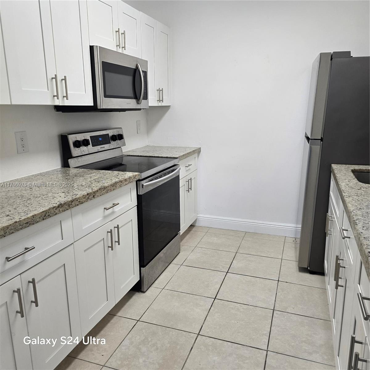 8200 Southwest 210th Street, Unit 111 Cutler Bay, FL 33189 - Photo 10 of 23 a kitchen with cabinets stainless steel appliances and a sink