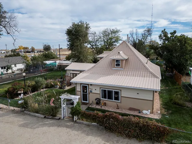 a view of house with yard and green space