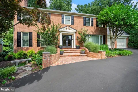 a front view of a house with a garden and yard