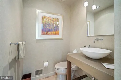 a large kitchen with a sink and cabinets