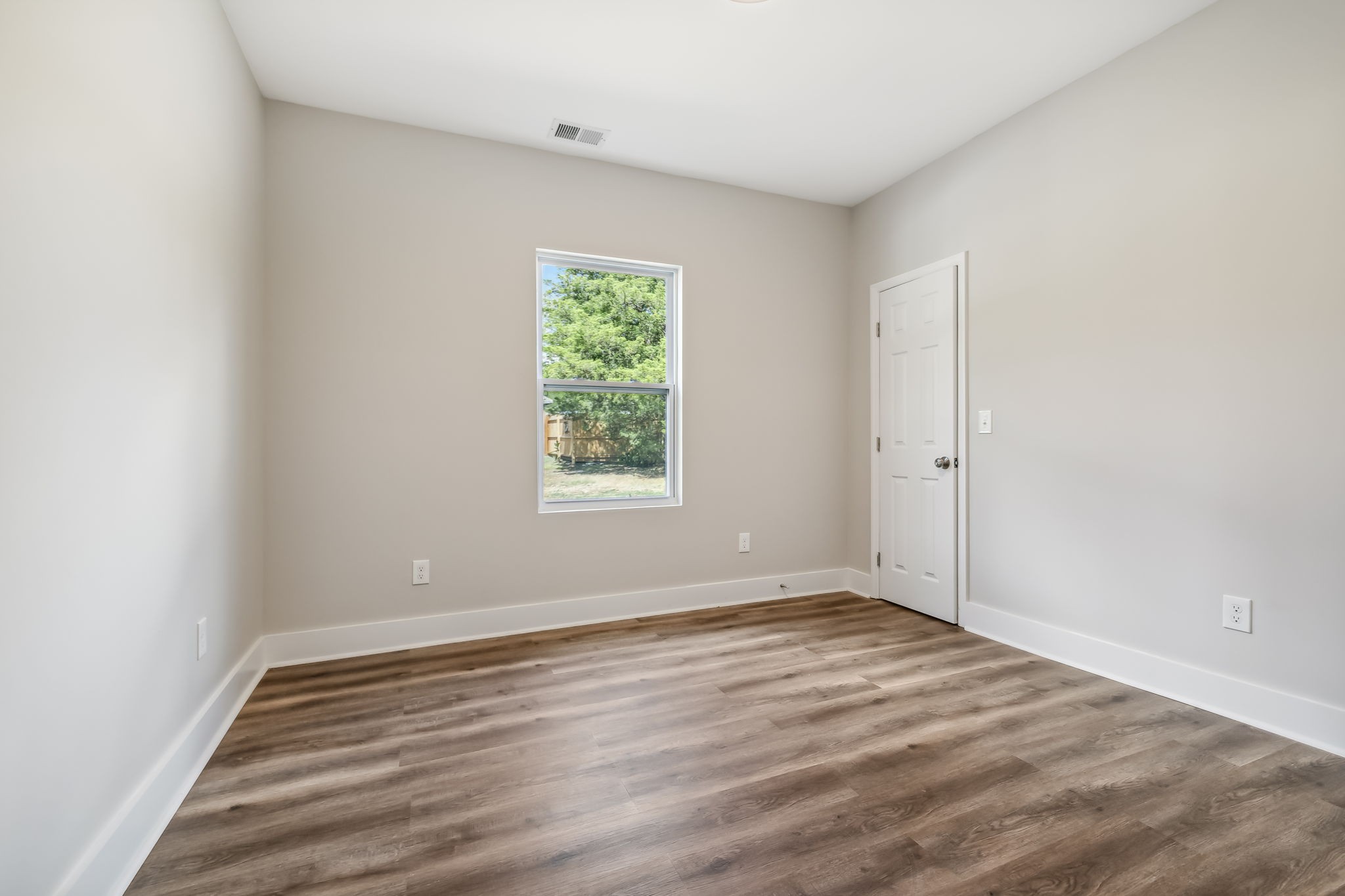 2801 Hunters Point Pike Lebanon, TN 37087 - Photo 14 of 23 an empty room with wooden floor and windows