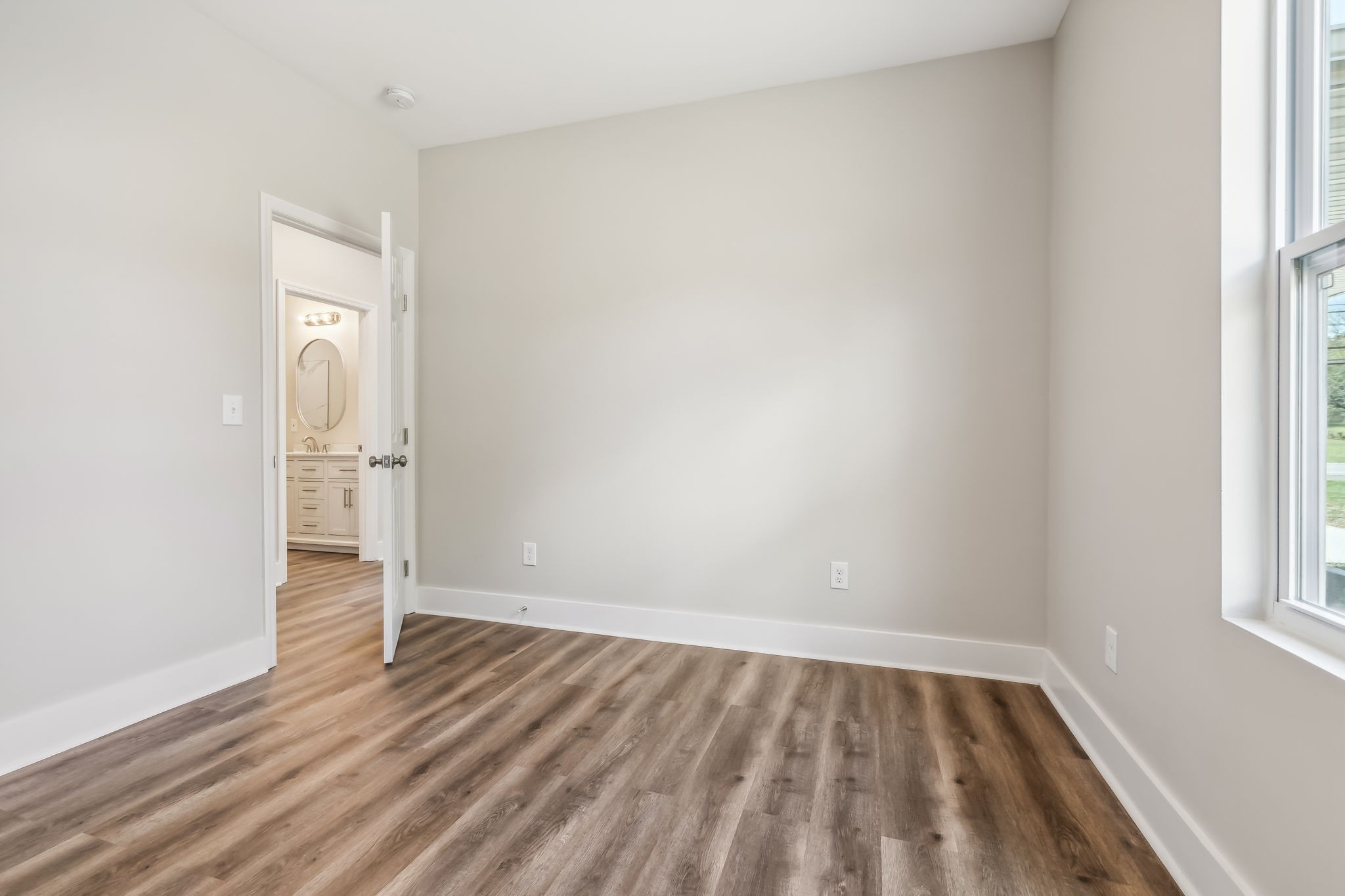 2801 Hunters Point Pike Lebanon, TN 37087 - Photo 15 of 23 an empty room with wooden floor and windows