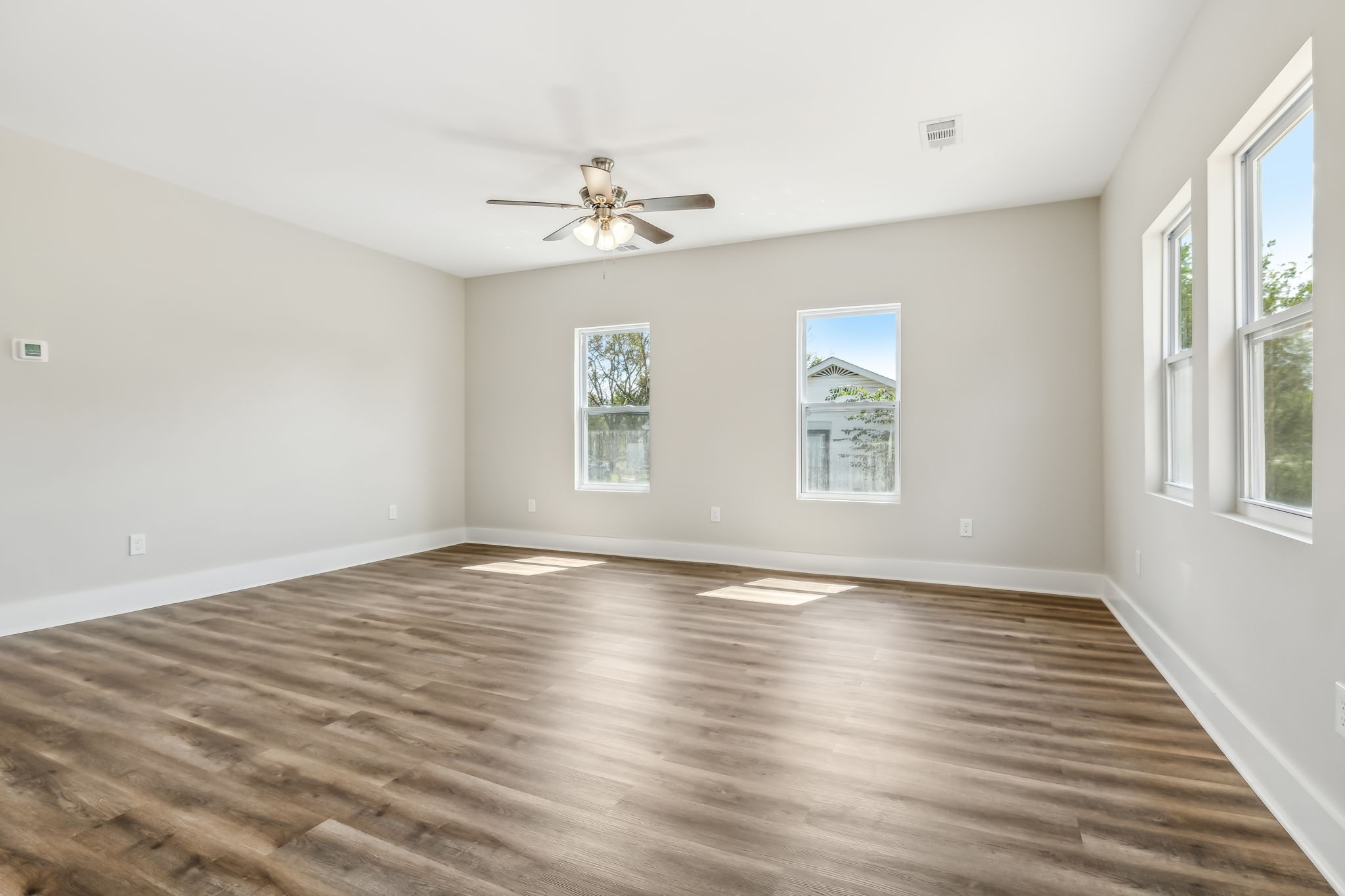 2801 Hunters Point Pike Lebanon, TN 37087 - Photo 7 of 23 an empty room with wooden floor chandelier fan and windows