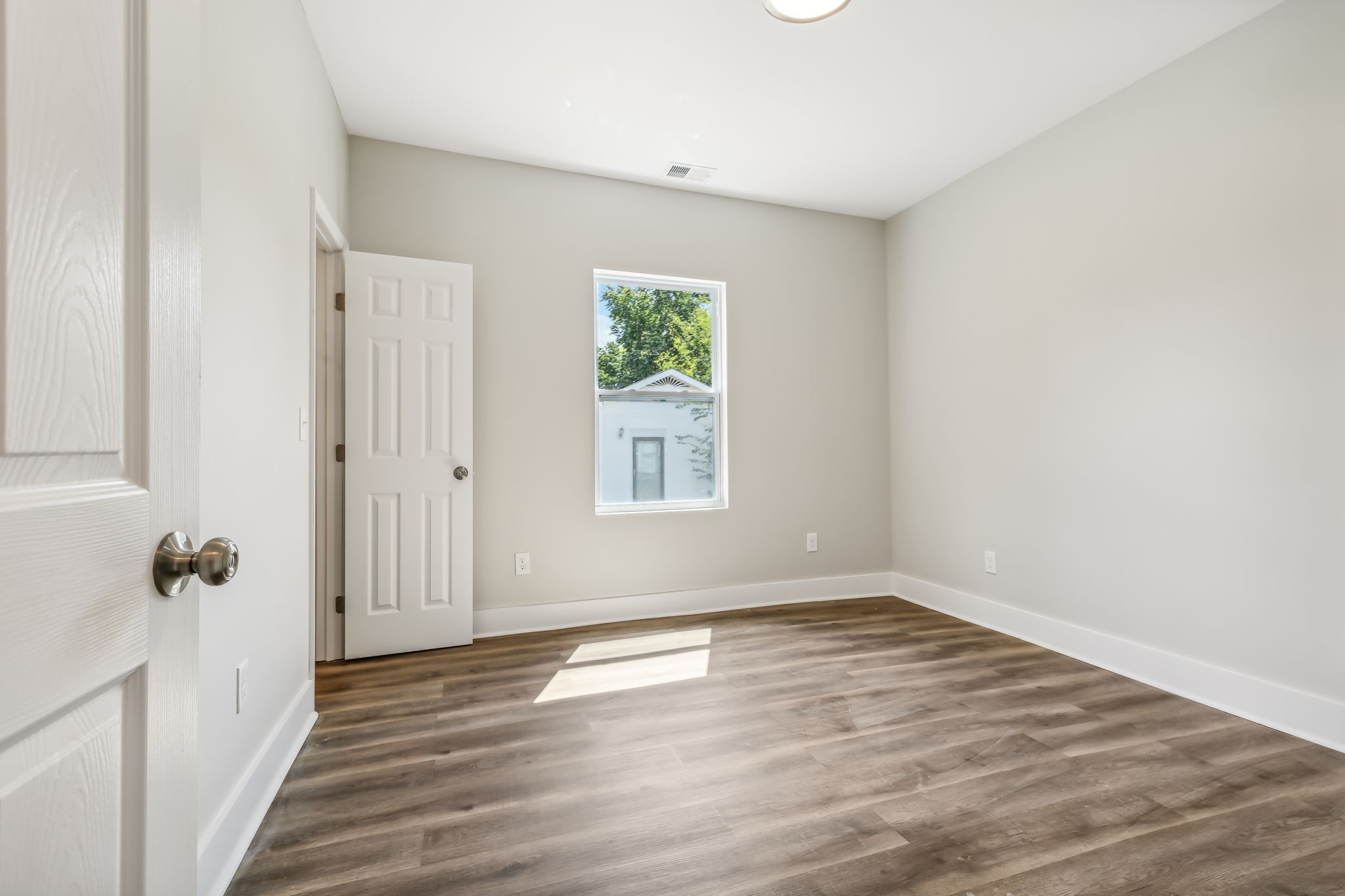 2801 Hunters Point Pike Lebanon, TN 37087 - Photo 10 of 23 an empty room with wooden floor and a window