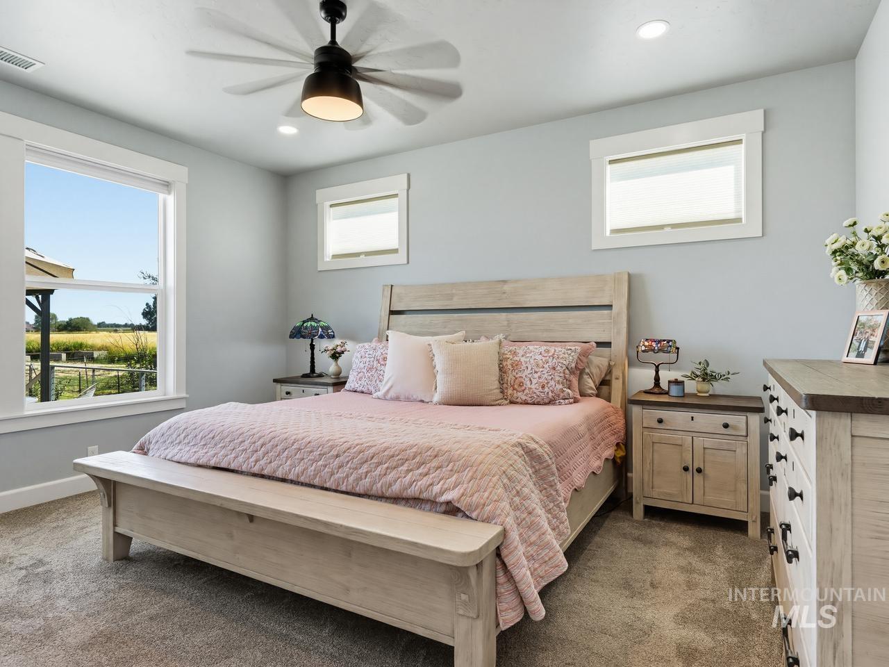4950 West Columbia Road Nampa, ID 83687 - Photo 22 of 50 Bedroom featuring a large double-hung window, light gray wall color, recessed lighting, and a ceiling fan with light