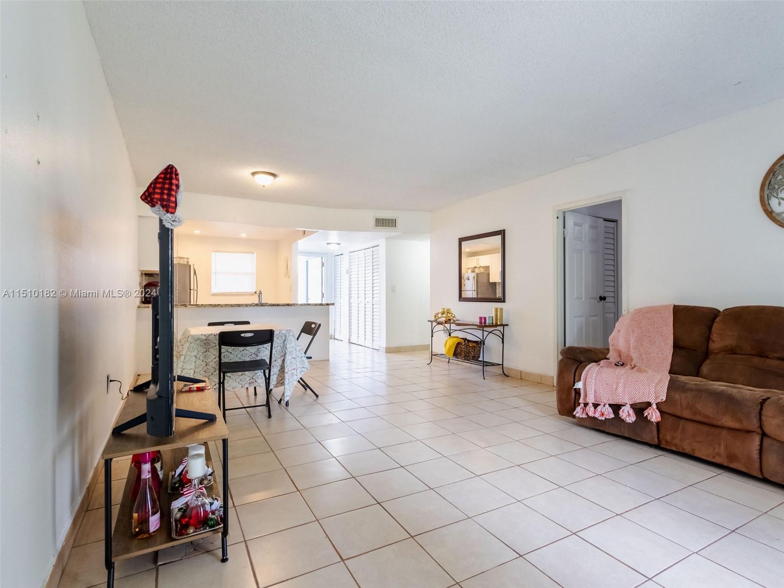 8331 Sands Point Boulevard, Unit C108 Tamarac, FL 33321 - Photo 22 of 46 a living room with furniture and a table