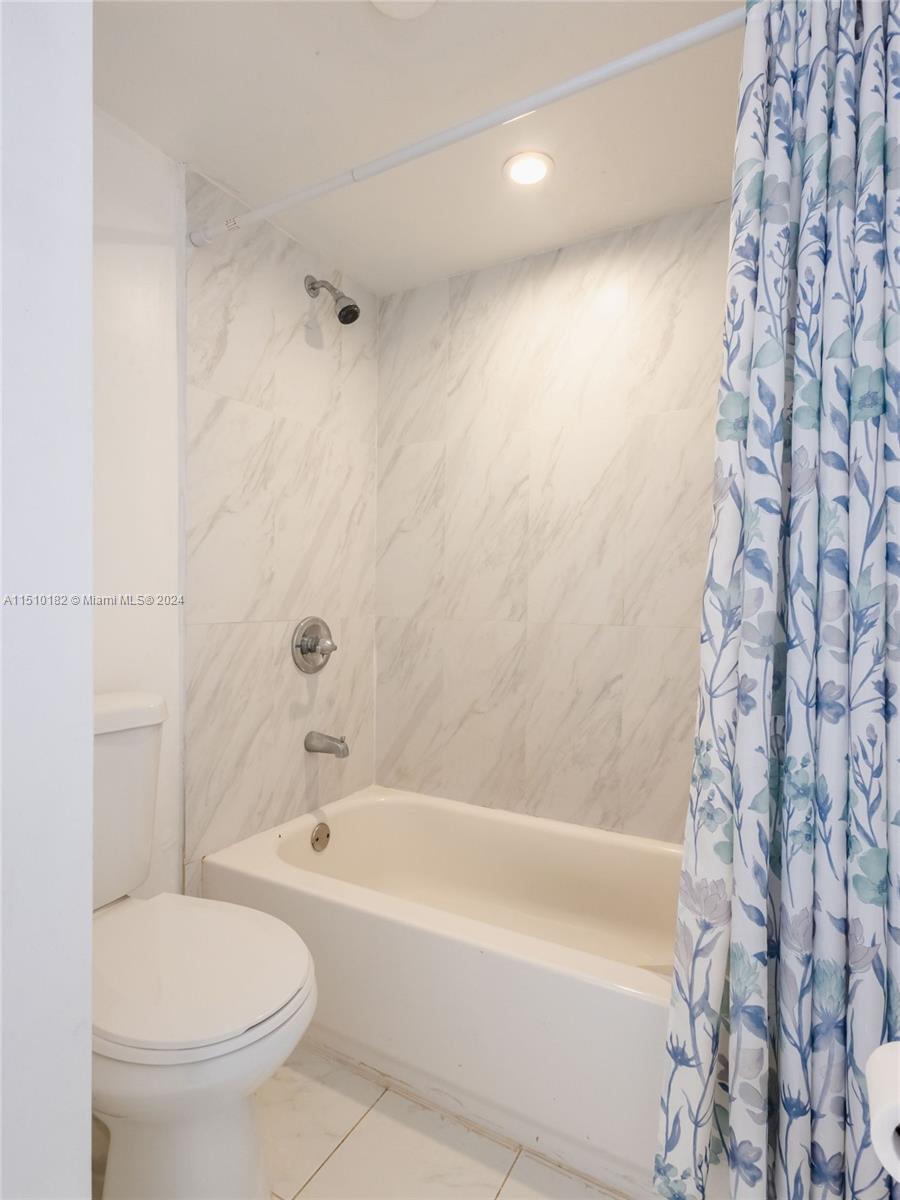 8331 Sands Point Boulevard, Unit C108 Tamarac, FL 33321 - Photo 29 of 46 a white bath tub sitting next to a white toilet