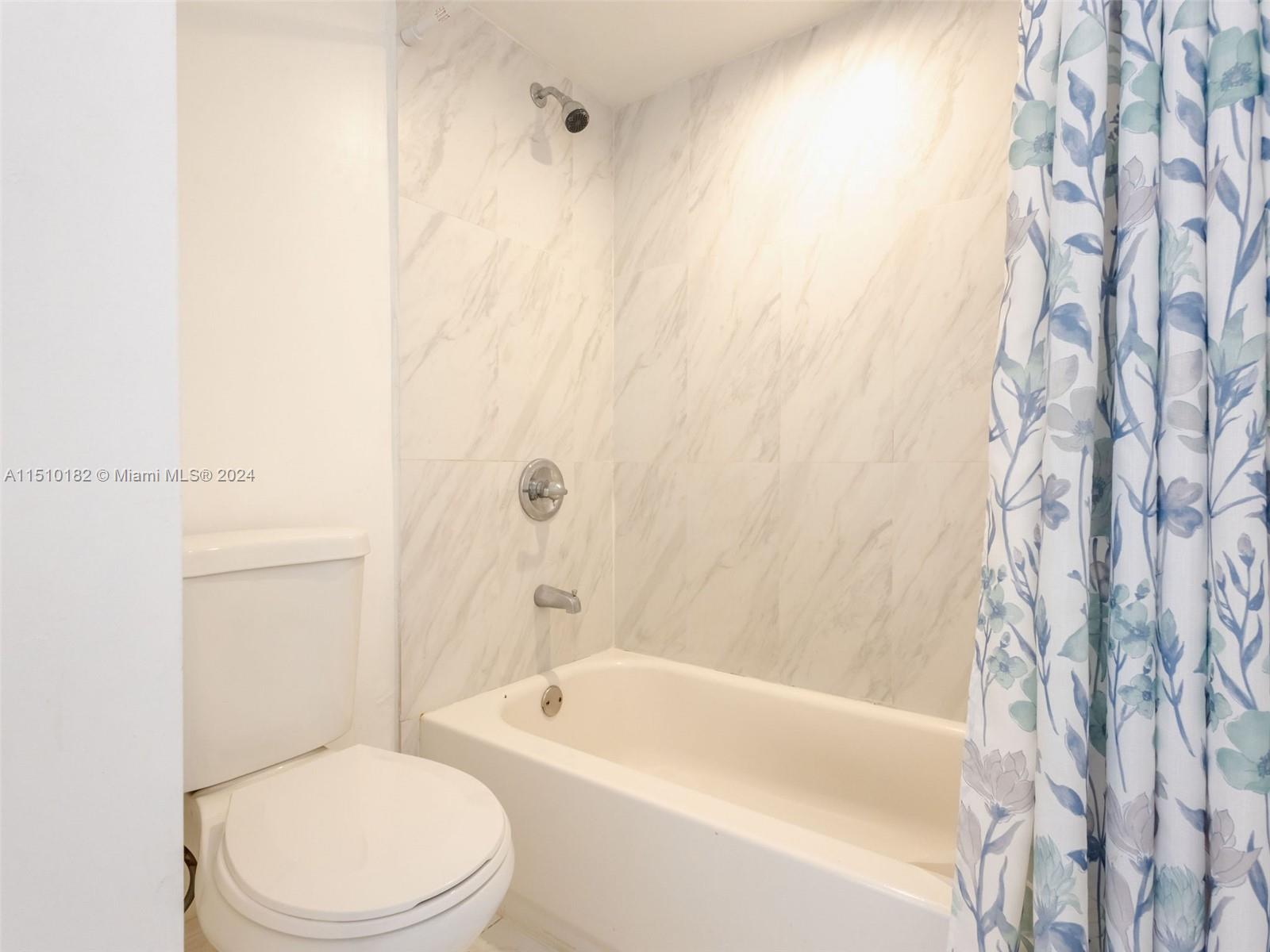 8331 Sands Point Boulevard, Unit C108 Tamarac, FL 33321 - Photo 30 of 46 a bathroom with a toilet and a bathtub