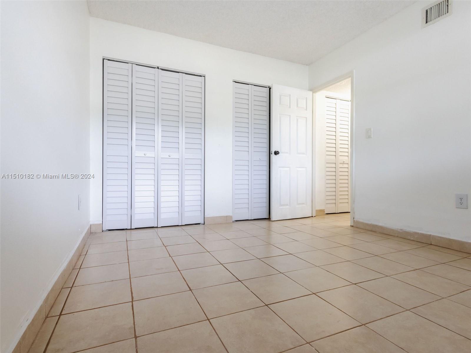 8331 Sands Point Boulevard, Unit C108 Tamarac, FL 33321 - Photo 34 of 46 an empty room with windows