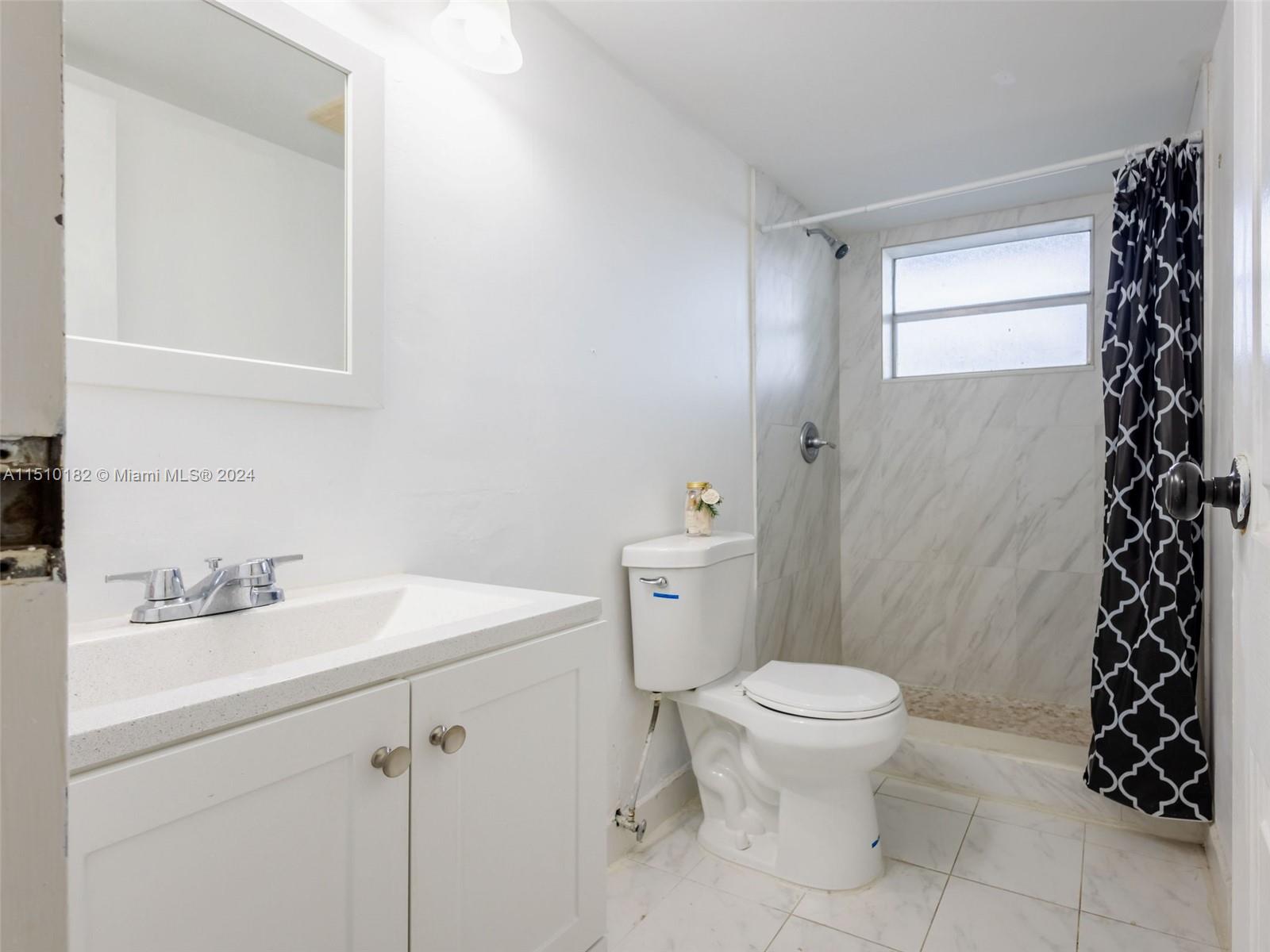 8331 Sands Point Boulevard, Unit C108 Tamarac, FL 33321 - Photo 35 of 46 a bathroom with a sink toilet and shower