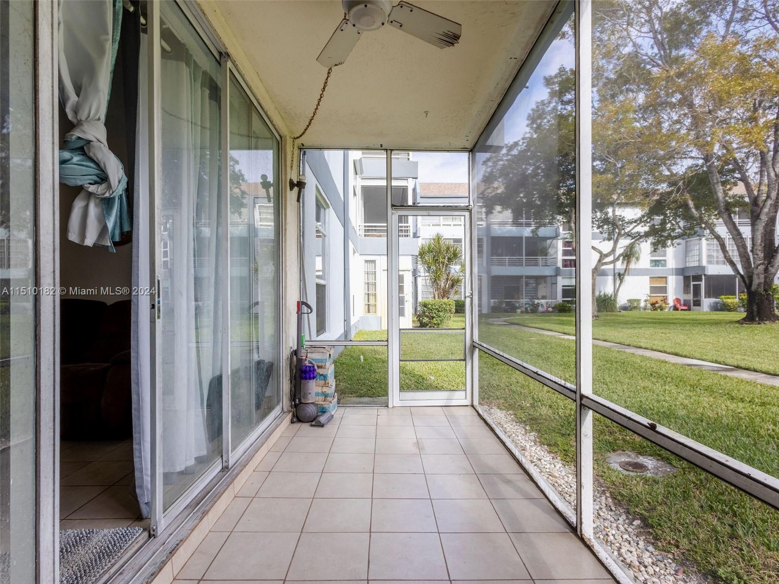 8331 Sands Point Boulevard, Unit C108 Tamarac, FL 33321 - Photo 39 of 46 a view of a house with a porch