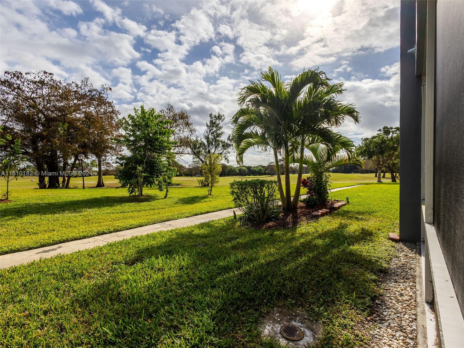 8331 Sands Point Boulevard, Unit C108 Tamarac, FL 33321 - Photo 4 of 46 a view of a park with large trees