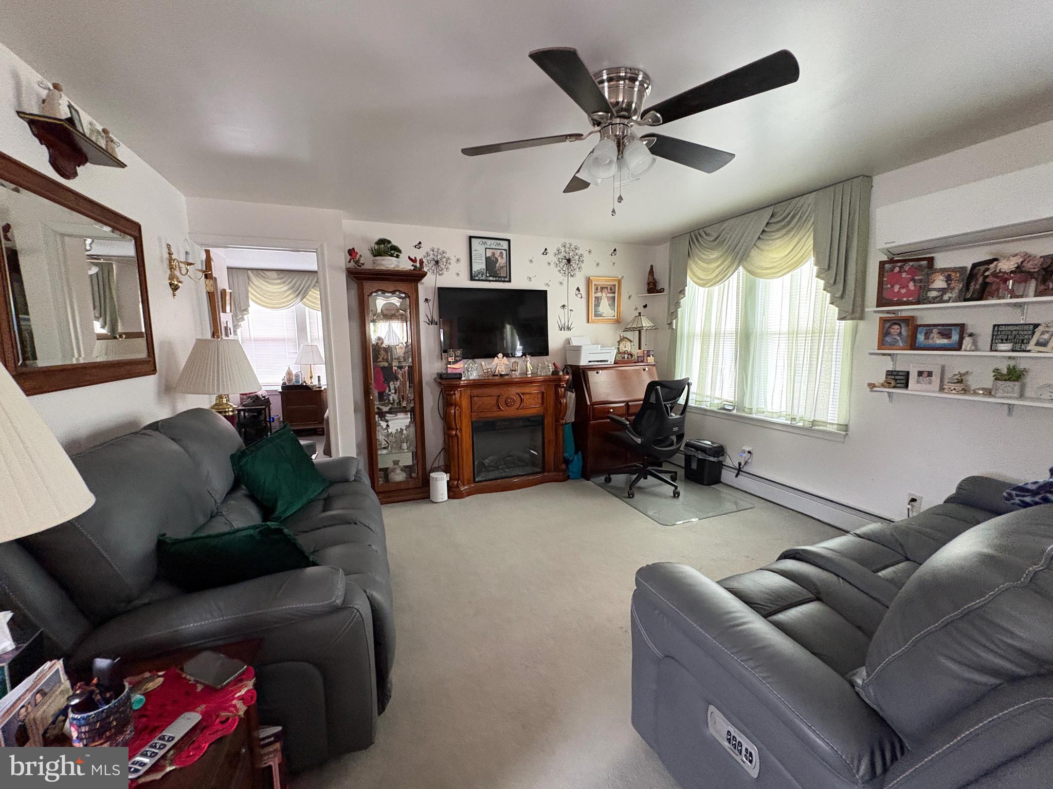 15 South Forklanding Road Maple Shade, NJ 08052 - Photo 5 of 30 a living room with furniture a flat screen tv and a fireplace