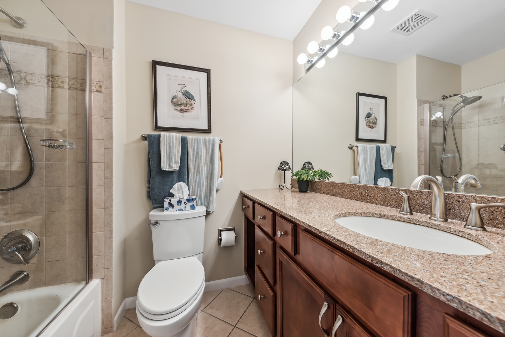 1027 Auburn Lane, Unit 1027 Buffalo Grove, IL 60089 - Photo 11 of 15 a bathroom with a granite countertop toilet sink and mirror