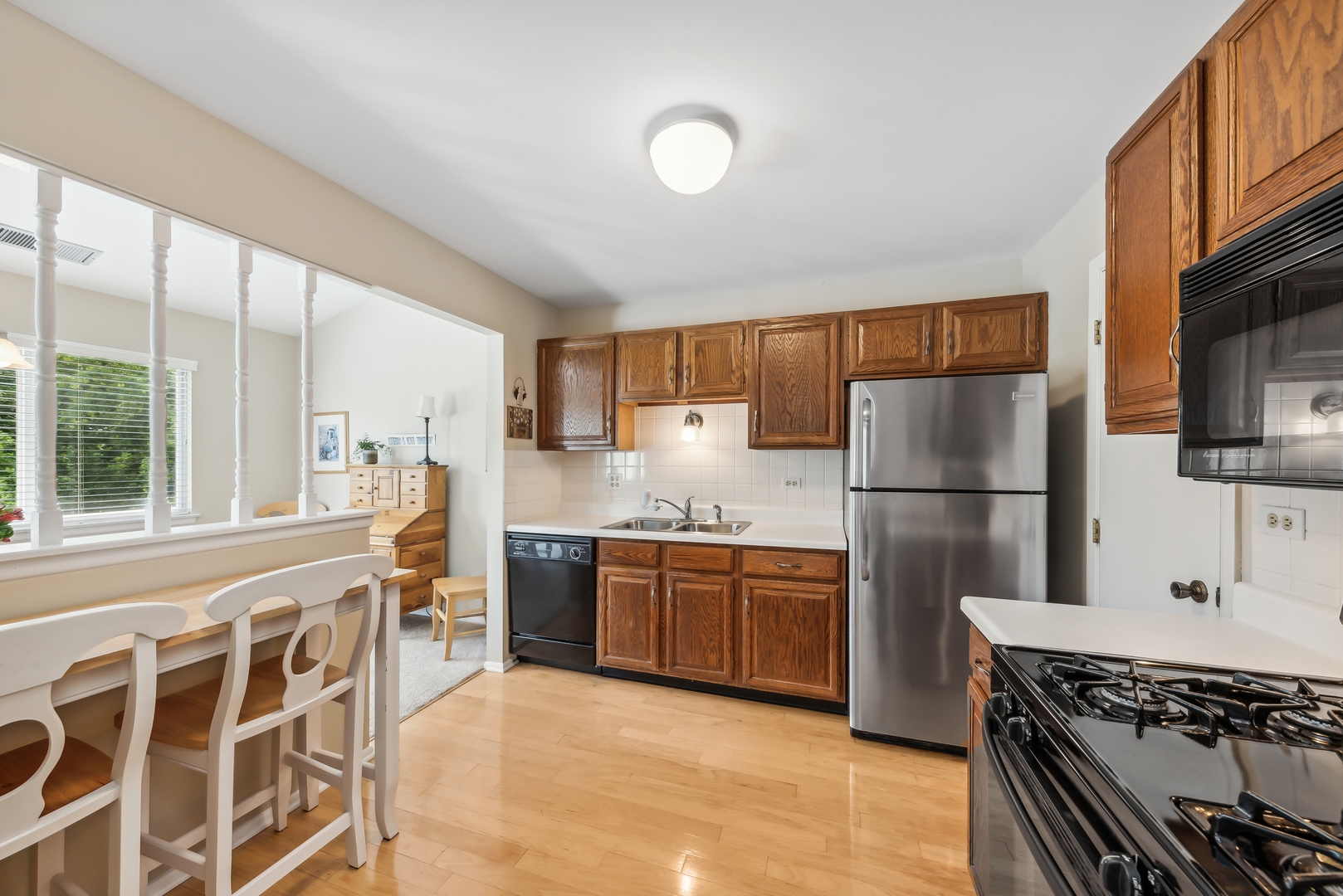 1027 Auburn Lane, Unit 1027 Buffalo Grove, IL 60089 - Photo 5 of 15 a kitchen with stainless steel appliances granite countertop a refrigerator and a stove top oven