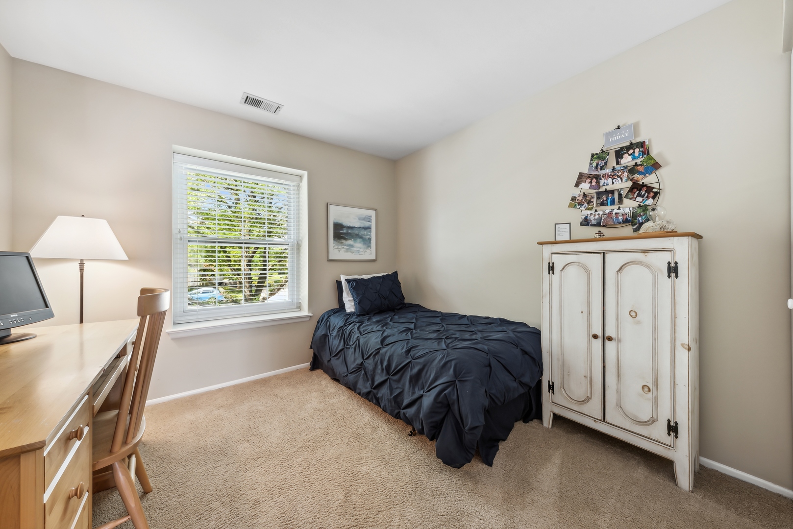 1027 Auburn Lane, Unit 1027 Buffalo Grove, IL 60089 - Photo 10 of 15 a spacious bedroom with a bed a table and a chandelier