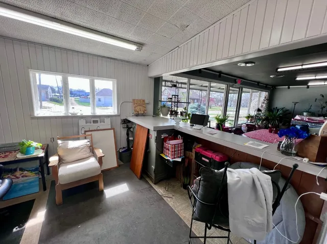 a living room with furniture a flat screen tv and a window