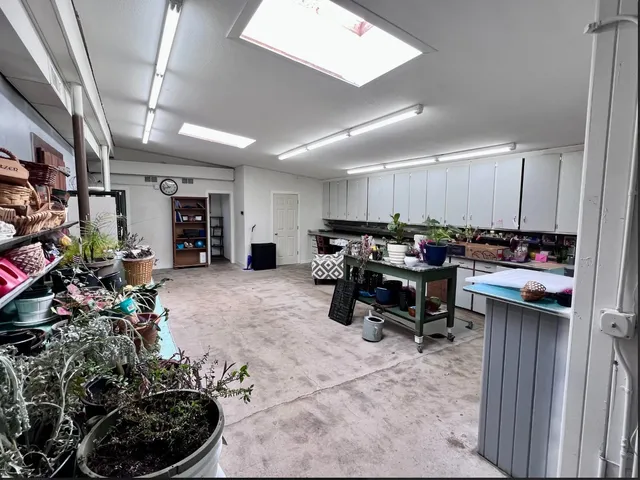 a room with lots of furniture and white walls