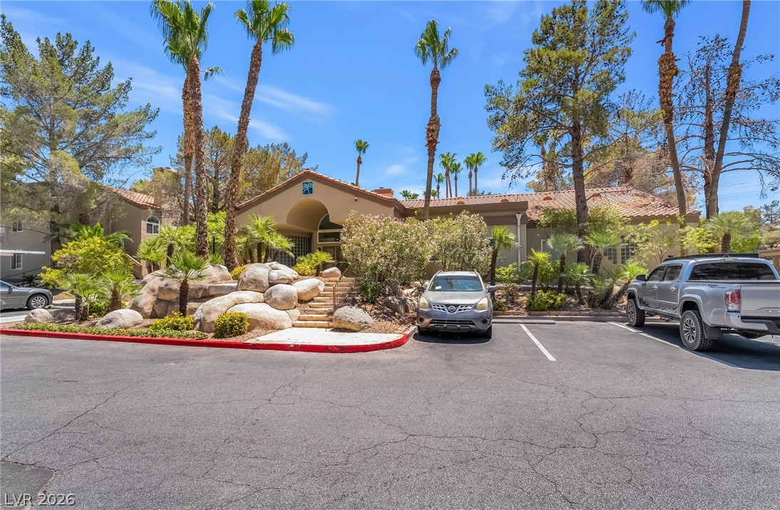 3145 East Flamingo Road, Unit 1092 Las Vegas, NV 89121 - Photo 25 of 33 A terracotta-roofed clubhouse welcomes with abundant landscaping and an inviting entry.