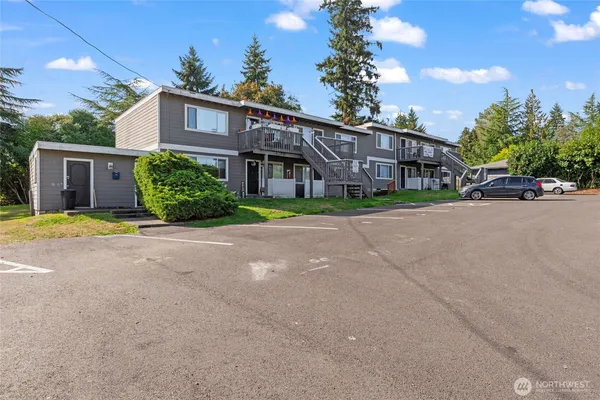 a view of a house with a yard and potted plants