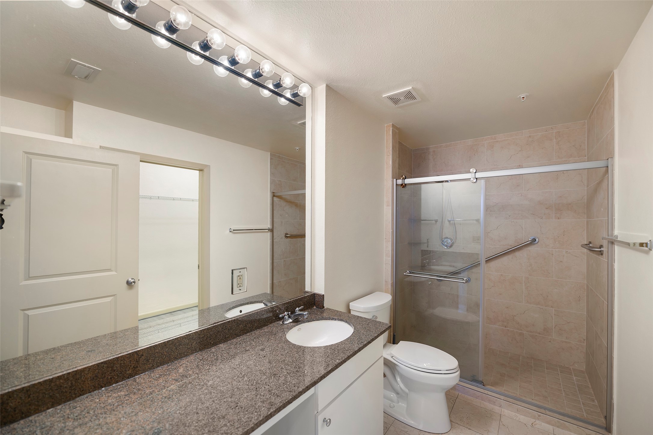 3505 Sage Road, Unit 314 Houston, TX 77056 - Photo 15 of 24 a bathroom with a granite countertop sink toilet and shower