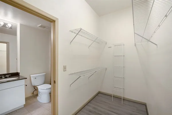 a bathroom with a granite countertop toilet and a shower