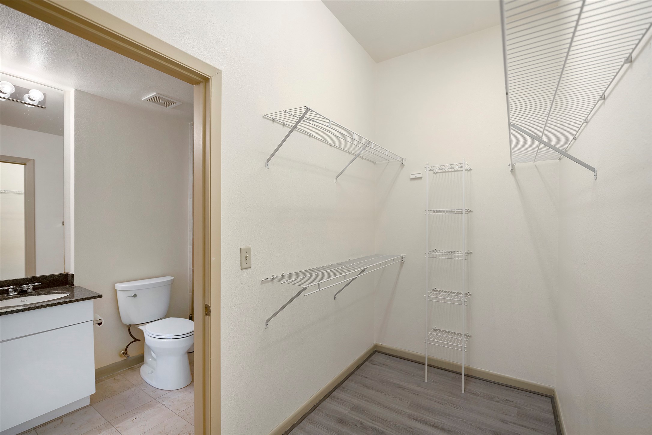 3505 Sage Road, Unit 314 Houston, TX 77056 - Photo 16 of 24 a bathroom with a granite countertop toilet and a shower