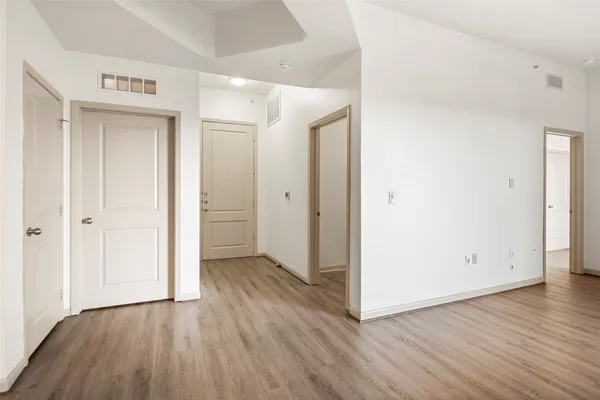 an empty room with wooden floor