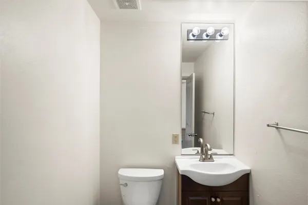 a bathroom with a sink toilet and mirror