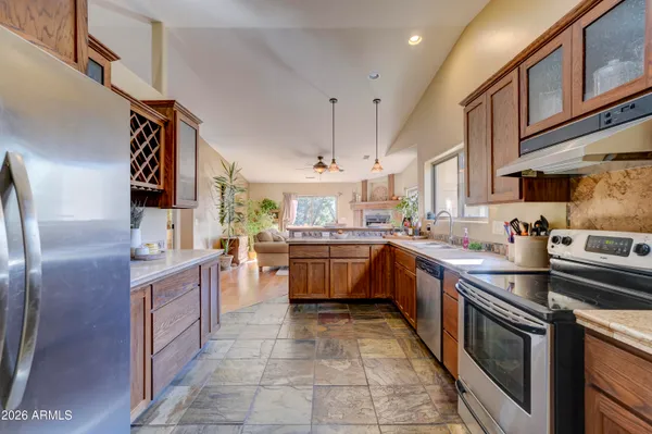a living room with furniture a large window and a fireplace