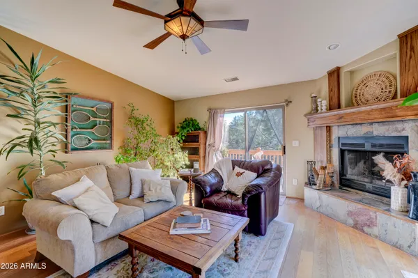 a living room with a bed furniture and a large window
