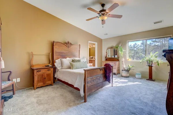 a bathroom with a granite countertop sink a large mirror and a bathtub