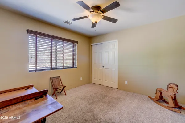 a bedroom with a bed and a television