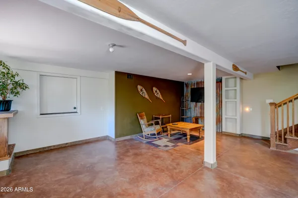a balcony with wooden floor and outdoor seating