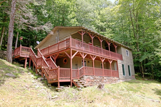 a view of a wooden house with a yard