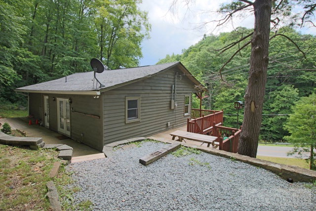 148 Grady Winkler Road Boone, NC 28607 - Photo 12 of 24 a backyard of a house with table and chairs under an umbrella