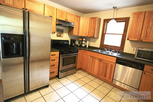 148 Grady Winkler Road Boone, NC 28607 - Photo 24 of 24 a kitchen with granite countertop a refrigerator stove and sink