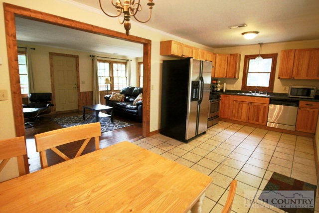 148 Grady Winkler Road Boone, NC 28607 - Photo 3 of 24 a kitchen with stainless steel appliances kitchen island granite countertop a refrigerator a stove a sink and dishwasher