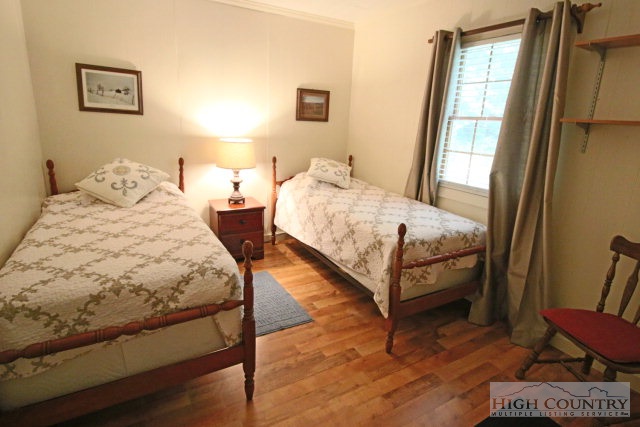 148 Grady Winkler Road Boone, NC 28607 - Photo 5 of 24 a bedroom with two beds and a window