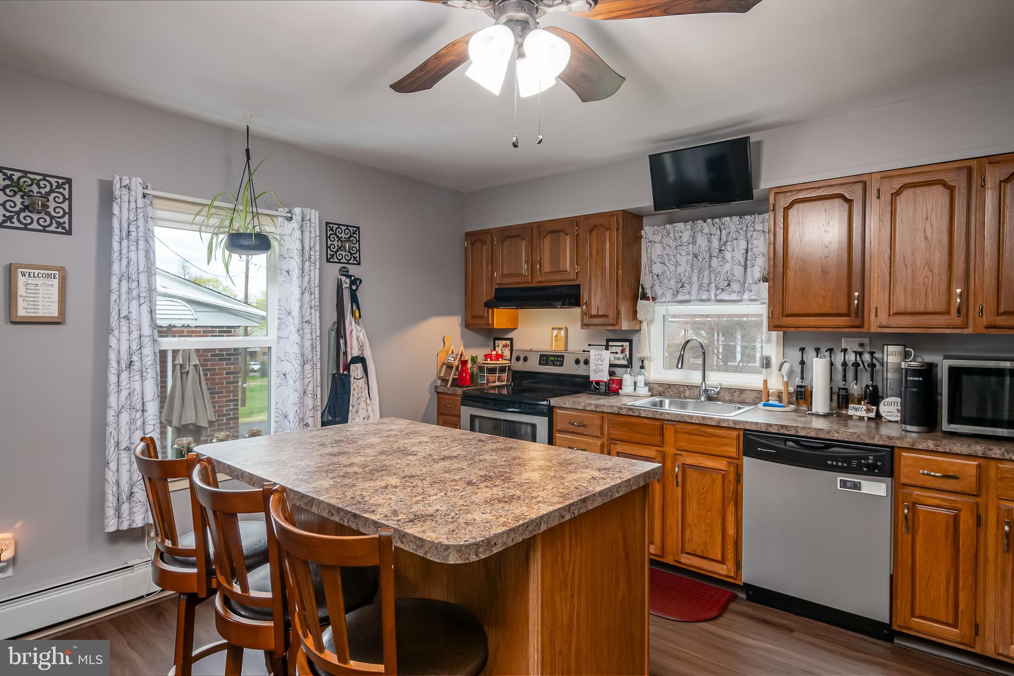 300 Old Fritztown Road Reading, PA 19607 - Photo 13 of 28 a kitchen with a stove a sink dishwasher a dining table and chairs with wooden floor