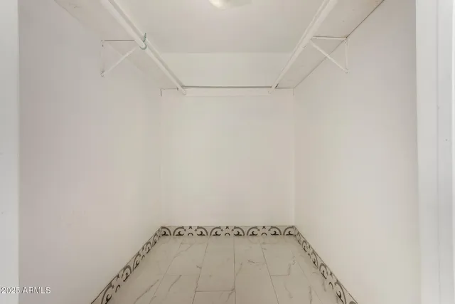 a view of a room with rack on the wall and a window