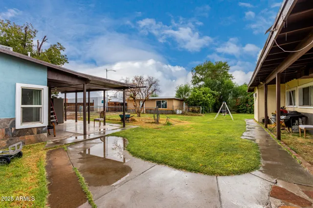 a backyard of a house with yard and tree