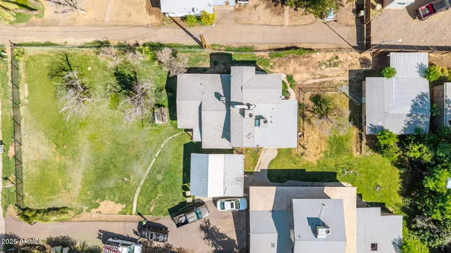 an aerial view of a house with swimming pool patio and outdoor seating
