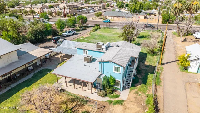 an aerial view of a house with swimming pool garden and patio