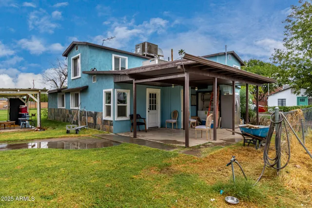 a view of a house with a yard patio and fire pit