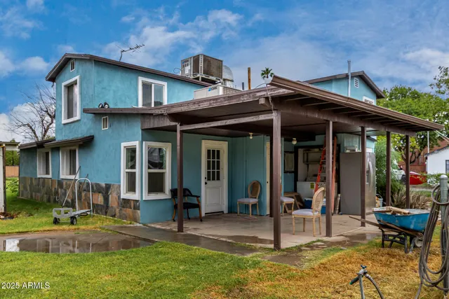 a view of a house with backyard porch and sitting area