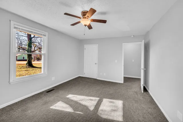a view of an empty room with a window