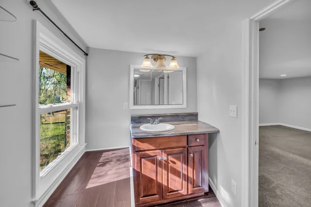a bathroom with a sink a vanity and a mirror