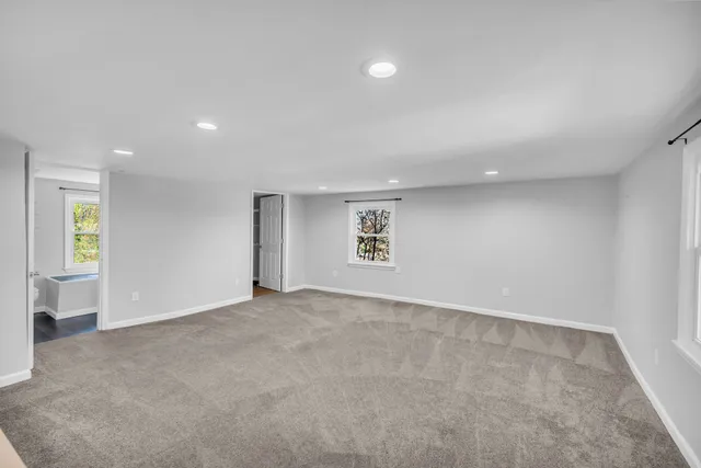 an empty room with windows and entrance